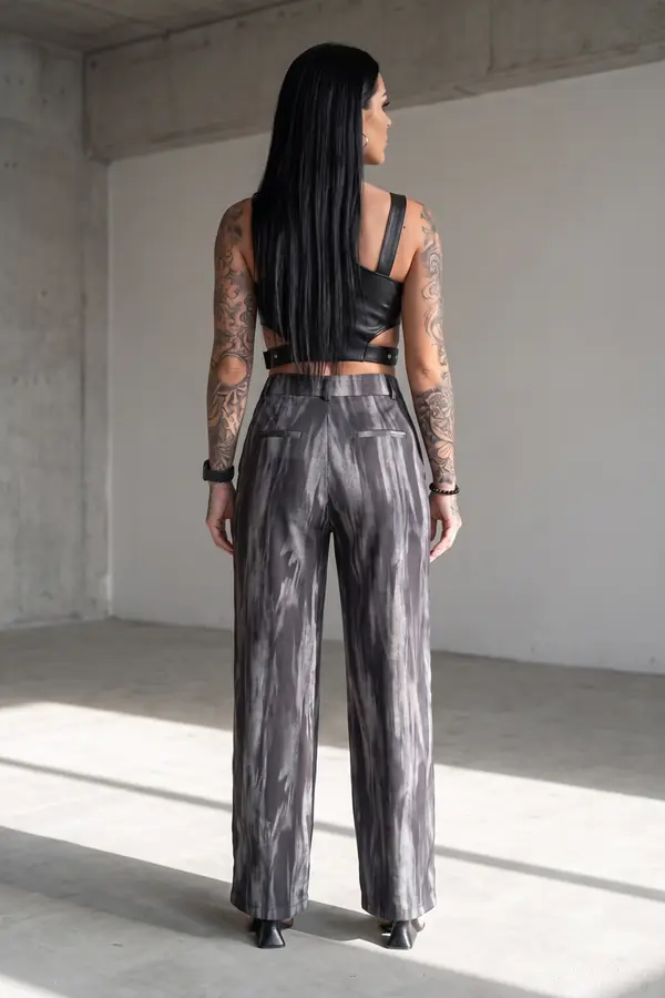 back & profile: Leather buckle crop top with marbled grey wide-leg trousers