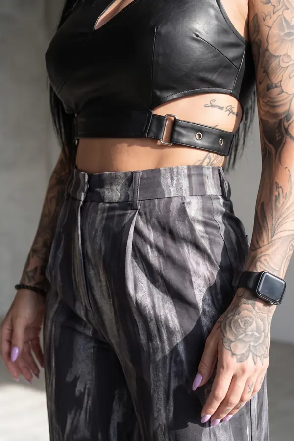 detail: Leather buckle crop top with marbled grey wide-leg trousers