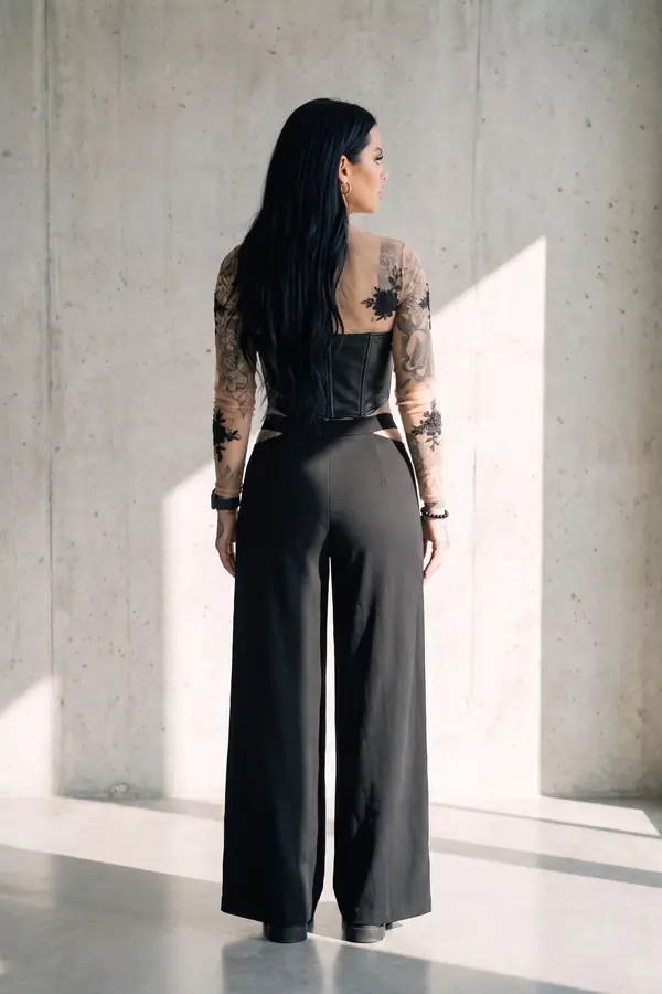 back & profile: Leather corset, lace mesh top and cut-out wide-leg trousers
