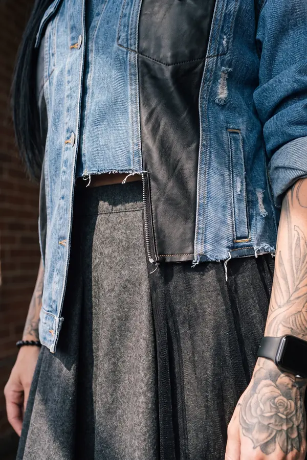 detail: Leather-panel denim jacket and asymmetric wool skirt