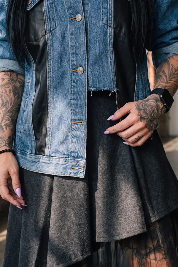 detail: Leather-panel denim jacket and asymmetric wool skirt