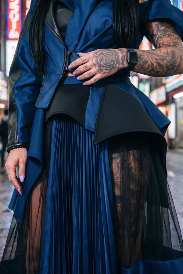 detail: Navy satin and leather jacket with a pleated tulle skirt