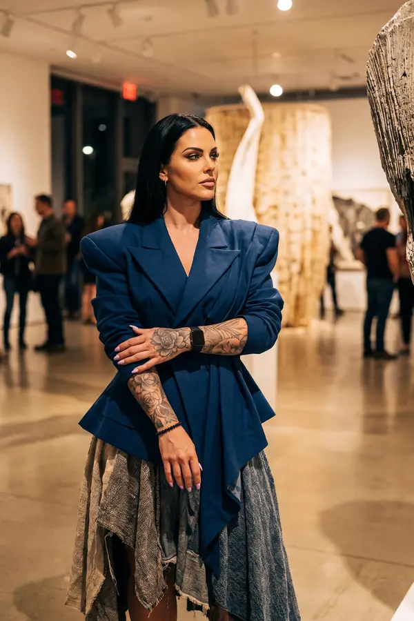 in motion: Navy sculpted-shoulder blazer over a patchwork skirt