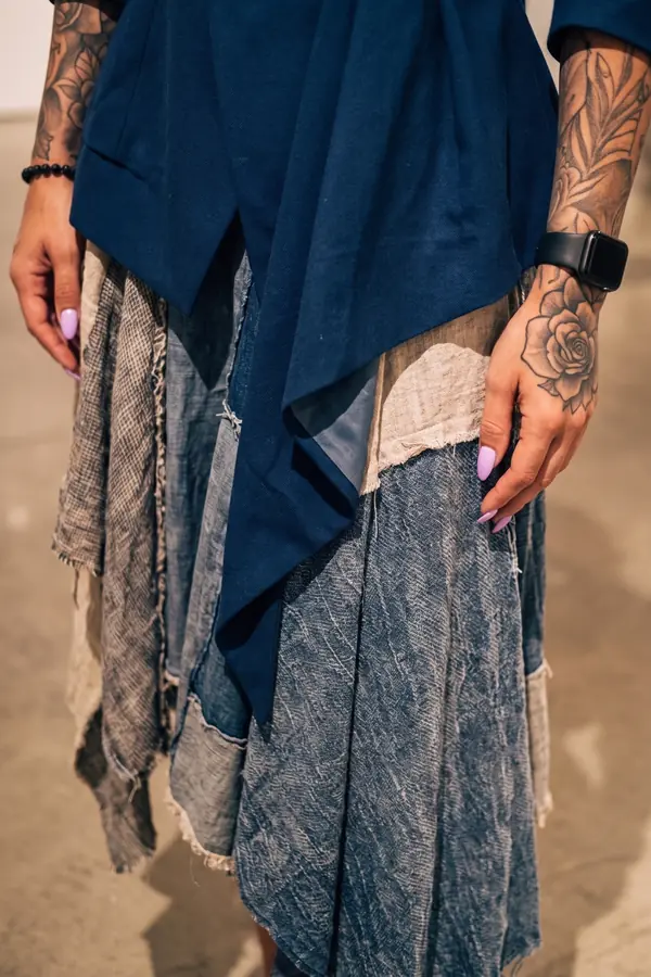 detail: Navy sculpted-shoulder blazer over a patchwork skirt