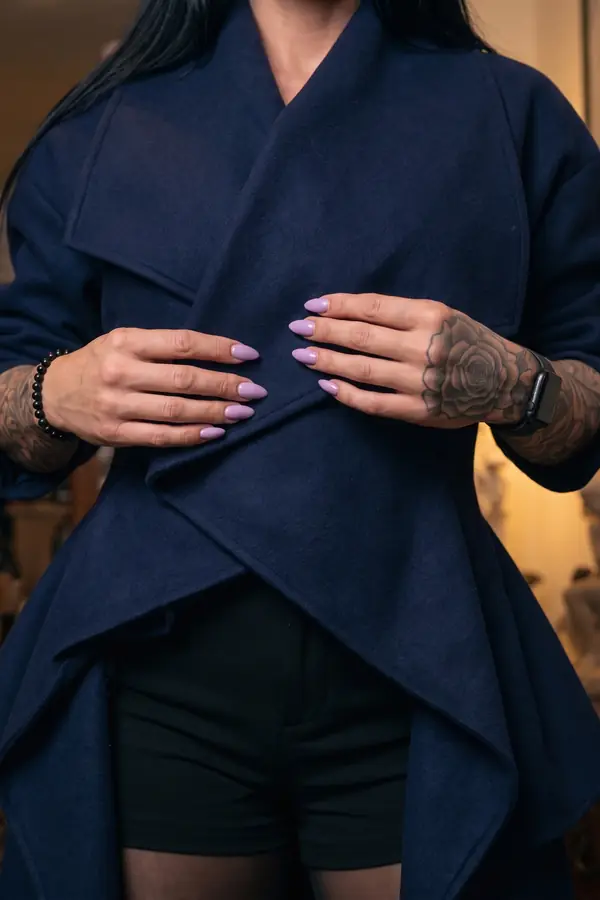 detail: Navy wool waterfall coat with black tailored shorts