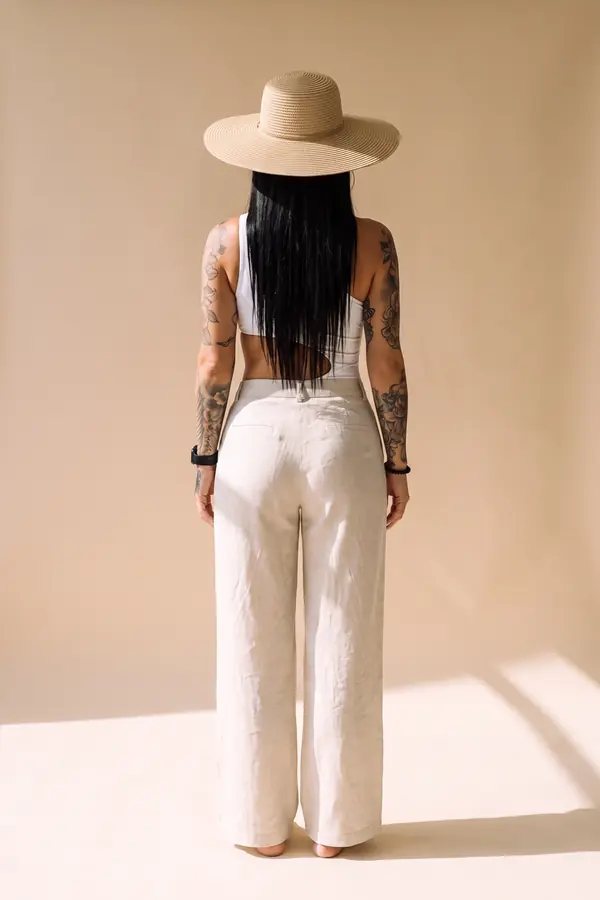 back & profile: One-shoulder cut-out bodysuit with linen wide-leg trousers