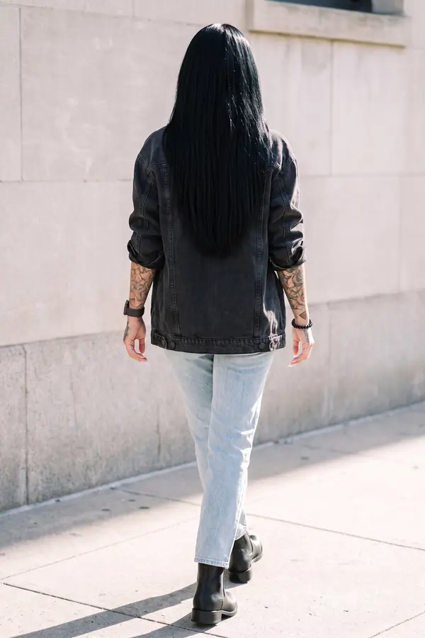 back & profile: Oversized black denim jacket with light-wash straight jeans