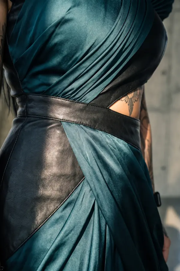 detail: Petrol satin and leather gown with pleated shoulders