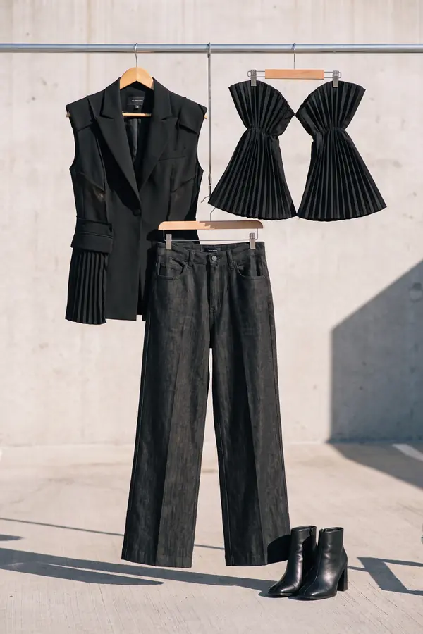 still life: Pleated-sleeve sleeveless blazer and black denim trousers