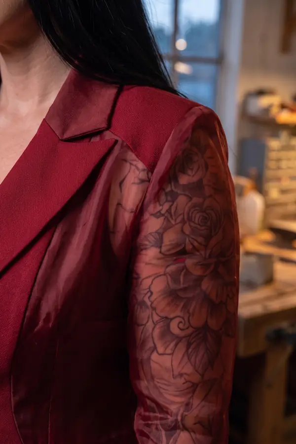 detail: Red crepe blazer with organza sleeves and layered skirt