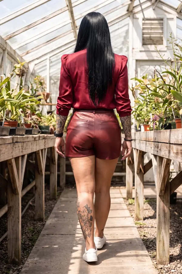 back & profile: Red satin jabot blouse with oxblood leather shorts