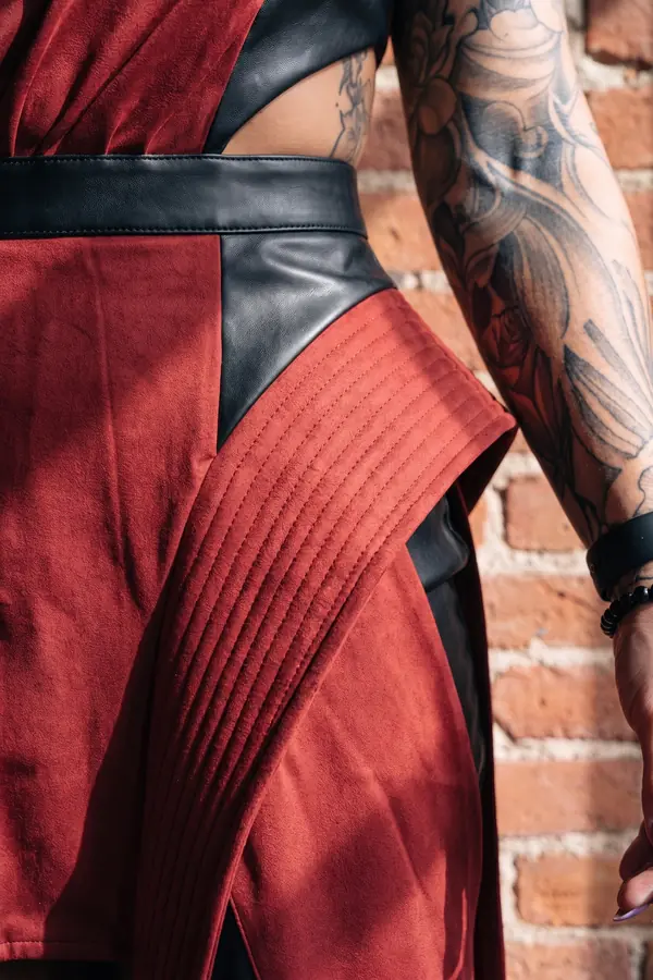 detail: Red suede one-shoulder gown with black leather panels