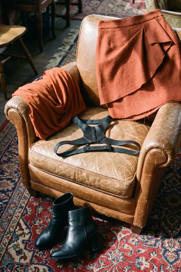 still life: Rust draped top with leather straps and a wrap mini skirt