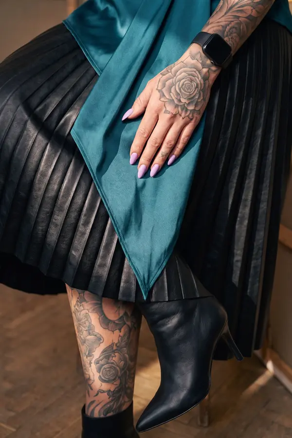detail: Teal satin draped top with a pleated leather midi skirt