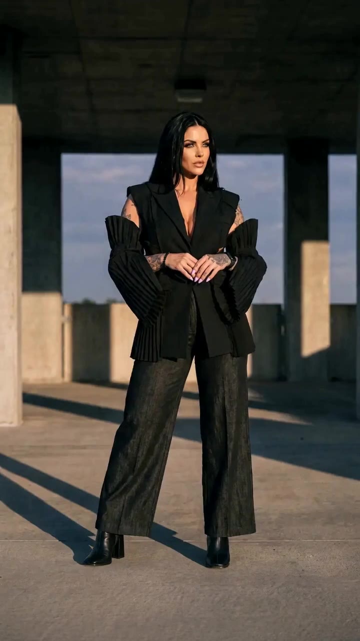 in motion: Pleated-sleeve sleeveless blazer and black denim trousers